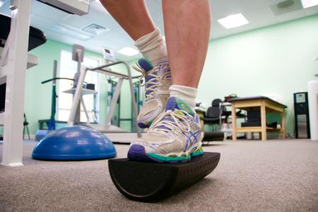 Close-up of feet balancing on a foam rocker board