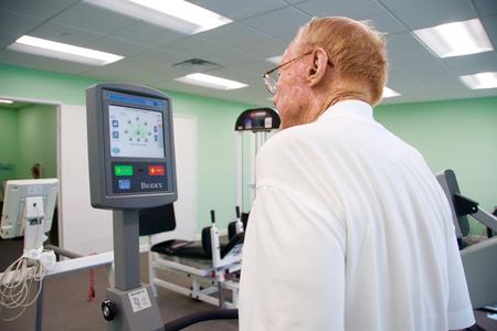 Older man using a Biodex balance system with a visual feedback screen